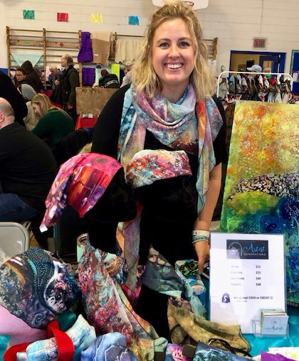 Reni Fee, co-owner of Artist Generations standing behind a booth at Dorval Elementary School Fall Fair.